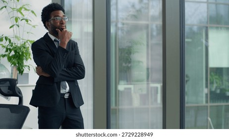 Thinking problem solution African American business man looking window in office decide trouble work job failure tired businessman hard difficult decision look think male hesitate puzzled entrepreneur