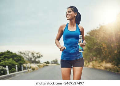 Thinking, runner or happy woman drinking water on break to hydrate or relax for healthy energy in exercise. Fitness, smile and thirsty athlete with liquid or hydration in marathon training or workout - Powered by Shutterstock