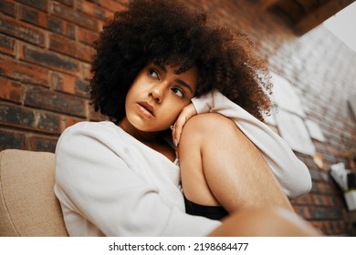 Thinking, Stress And Black Woman With Anxiety About Life, Loneliness And Depression. African Girl Alone, Thoughts On Trauma And Poor Mental Health In Her Apartment, Home Or House On A Couch Or Sofa