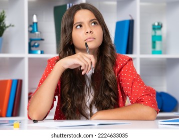 Thinking thoughtful teenager school girl. School student writing in exercise book, studying in classroom. Serious teenager schoolgirl. - Powered by Shutterstock