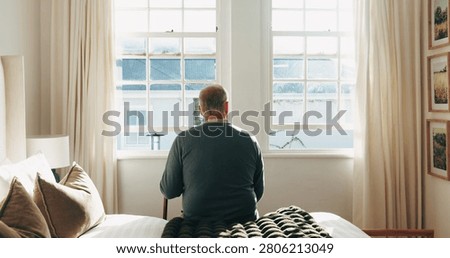 Thinking, window and back of senior man in bedroom for nostalgia, remember or reflection. Walking stick, dementia and elderly person in retirement on bed for relax, memory or flashback in house