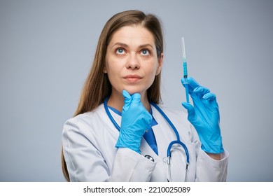 Thinking Woman Doctor Holding Syringe With Vaccine And Looking Up. Isolated Medical Worker Portrait.