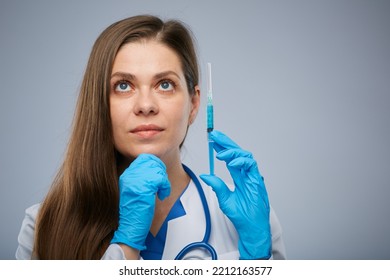 Thinking Woman Doctor Holding Syringe With Vaccine And Looking Up. Isolated Medical Worker Portrait.