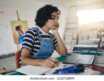 Thinking Woman, Laptop And Writing Notes For Online Art Business With Freelance Artist In Studio, Workshop Or Showroom Busy Working On The Internet. Creative Female Painter Or Student Doing Research