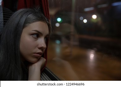 Thinking Woman Looking Out Of The Train Window At Night