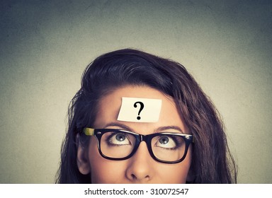 thinking woman with question mark on gray wall background - Shutterstock ID 310072547