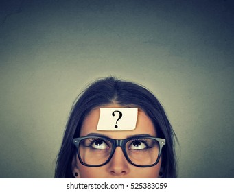 Thinking Woman With Question Mark On Gray Wall Background