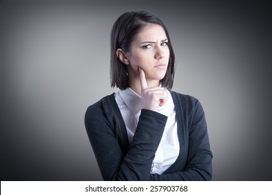 Thinking Woman Standing Pensive Contemplating Looking Skeptic.Thinking Business Woman Expressing Anger,confusion And Distrust.Young Brunette Looking Curious,evaluating Something