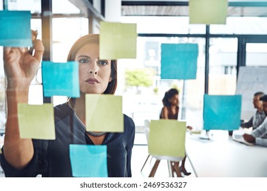 Thinking, writing and business woman planning presentation in office for schedule, goal or team calendar. Agenda, idea or sticky note with creative, vision or research results for storyboard mind map - Powered by Shutterstock