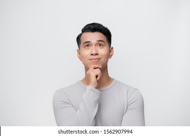 Thinking Young Asian Man Isolated On White Background.