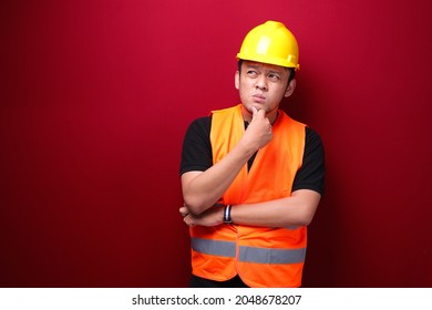 Thinking Young Asian Man Worker Is Seriously Think Gesture On Red Background