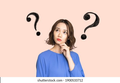 Thinking young asian woman. Confused facial expression. - Shutterstock ID 1900533712