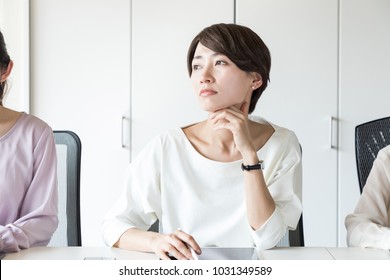 Thinking Young Woman In The Office.