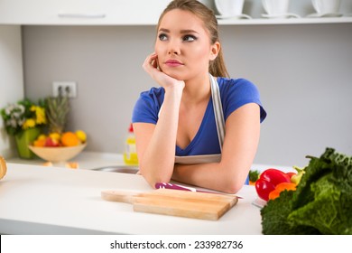 Thinking Young Woman Wondering What To Cook In Kitchen 