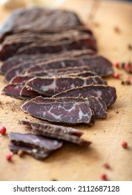 Thinly Sliced Simple Beef Biltong on Wooden Cutting Board
