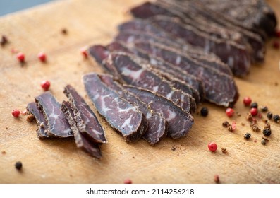 Thinly Sliced Simple Beef Biltong on Wooden Cutting Board - Shutterstock ID 2114256218