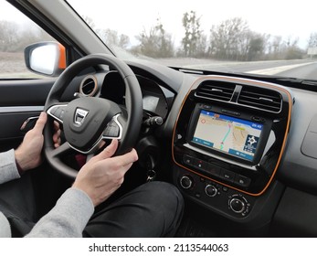 Thionville, Moselle, France - 27th January 2022: Man Driving Dacia Spring Showing The Interior, Dashboard, Instrument Panel, Navigation System