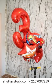 Third Birthday Decor For A Photoshoot Of A Toddler. Red Balloons Setup Of Car Theme 