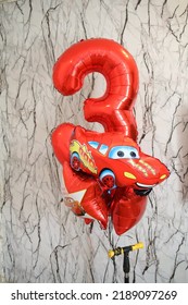 Third Birthday Decor For A Photoshoot Of A Toddler. Red Balloons Setup Of Car Theme 