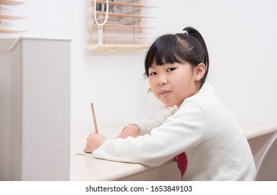 A Third Grade Elementary School Girl Studying