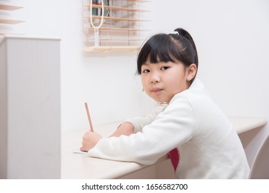 A Third Grade Elementary School Girl Studying