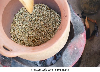 Third processing of vintage coffee bean by roasted in clay pot over charcoal