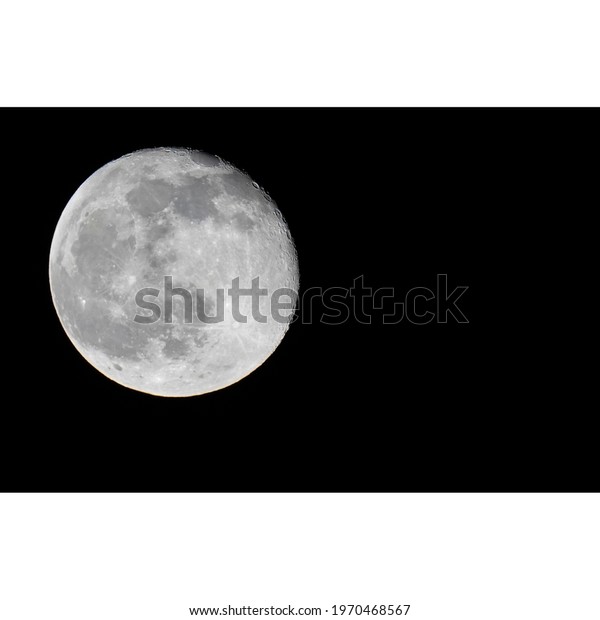third quarter Moon in a\
dark black sky 