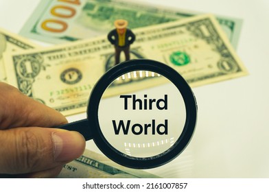 Third World.Magnifying Glass Showing The Words.Background Of Banknotes And Coins.basic Concepts Of Finance.Business Theme.Financial Terms.