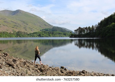 THIRLMERE, UK - MAY 28, 2017: Blonde Woman Fishing On A Lake On A Summer Day.