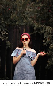 
Thirsty Girl Drinking Natural Juice Holding Cherries. Fashionable Woman Having An Organic Freshly Squeezed Fruity Beverage
