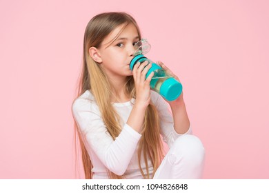 Thirsty Kid Drink Water For Health On Pink Background. Child Hold Water Bottle. Little Girl With Plastic Bottle. Thirst And Dehydration. Childhood Activity And Energy, Punchy Pastel Trend.