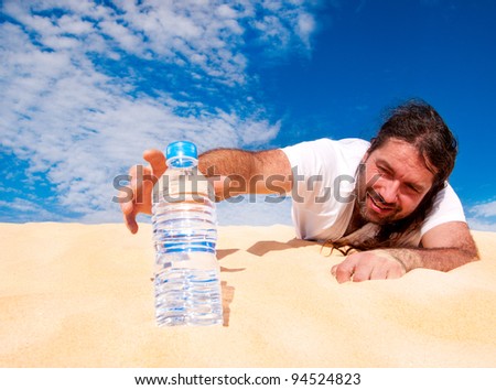 Thirsty man in the desert reaches for a bottle of water