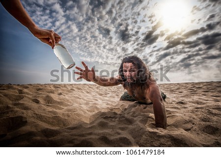 thirsty man in desert try to catch water bottle