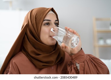 Thirsty Muslim Woman Drinking Clean Water From Glass