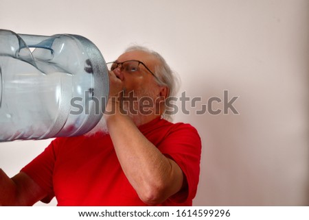 Thirsty old man drinking from a 5 gallon water bottle.
Thirst buster, thirsty gentleman drinks from a 5 gallon water bottle.
Thirsty man drinking
