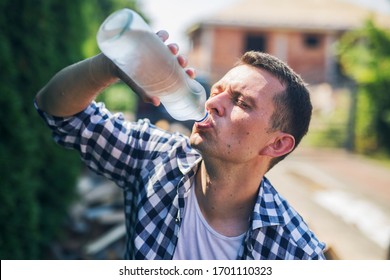 Thirsty tired lumberjack drinking water and sweating - Powered by Shutterstock