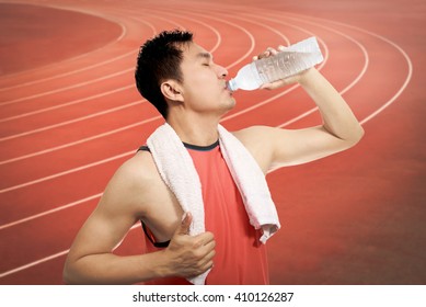 Thirsty Young Asian Handsome Athlete Drinking Water After Long Run