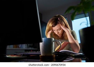 Thirty Years Old Tired Woman Working Late Remotely At Home Office, Using Computer, Remote Work Burnout