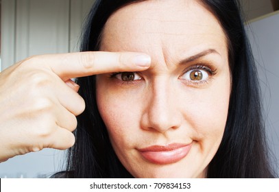 A Thirty-year-old Woman With Wrinkles On Her Forehead