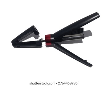 This is a 3-in-1 Multifunctional Bluetooth Selfie Stick Tripod. It features a compact, foldable design with a sleek black finish and a metallic red accent ring. The device serves as a handheld selfie stick with an extendable telescopic pole, but the handle also unfolds into a stable tripod base for hands-free photos or video calls. It includes an adjustable phone clamp that can rotate for both portrait and landscape orientations.