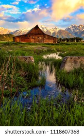 This abandoned barn in Jackson Hole, Wyoming is part of Mormon row and sits at the base of the Grand Teton snow capped mountains.  this landmark is on the National Register of Historic places.
