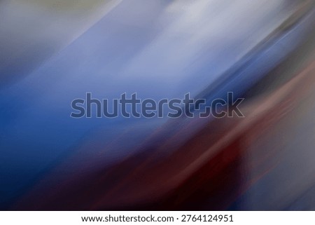 This abstract composition captures the fluid essence of motion and light. Through a technique of intentional camera movement, deep shades of indigo and slate blue are streaked with warm, organic pulses of crimson and copper. The mood is a sophisticated blend of melancholy and kinetic energy, evoking the feeling of a late-night drive through a rain-slicked city or the rushing passage of time.
This image is versatile and highly atmospheric, making it perfect for minimalist designs where a sense of depth and mystery is required. It works exceptionally well as a backdrop for high-end digital interfaces or as an evocative cover for creative media.