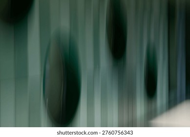 This abstract composition captures a sense of fluid motion through vertical motion blur and deep, oceanic tones. The interplay of dark, elliptical shadows against a rhythmic, teal-paneled background creates a dreamlike, cinematic atmosphere. It feels both mysterious and sophisticated, suggesting a world seen through a moving window or a distorted reflection. Atmosphere: Ethereal, moody, avant-garde, and contemplative. Energy: Calming yet slightly unsettling; a perfect balance of architectural structure and organic distortion. deal for ambient, techno, or experimental indie album covers. A compelling choice for literary fiction or psychological thriller book covers. High-end digital art prints for minimalist or corporate office spaces. A sophisticated background hero image for tech or architecture websites.