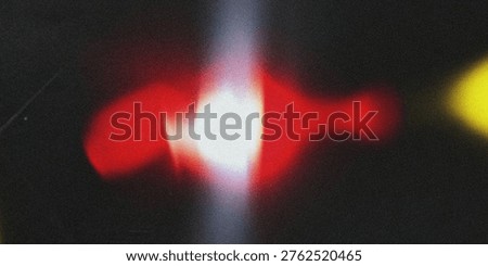 This abstract image captures a mesmerizing display of glowing red and yellow lights set against a dark background. The vibrant colors and blurry effects evoke a sense of energy, movement, and creativity, making it a unique and captivating visual experience.