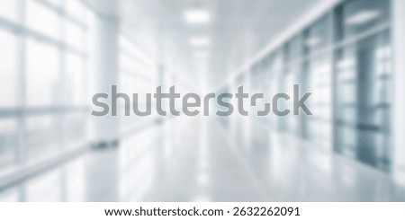 This abstract image represents a blurred long corridor that has ample light passing through large windows, creating a modern and spacious environment with high tech architecture blurry background