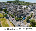 This aerial drone photo shows the beautiful city of Kendal in Cumbria, England. You can see some traffic around the old medieval church.