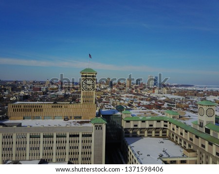 This is an aerial photo that showcases Milwaukee Wisconsin, as well as the Bradley clock tower. This is a winter shot that showcases the whole city of Milwaukee