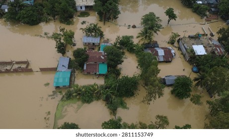 This aerial photograph captures the devastating impact of flooding in Bangladesh, where rising floodwaters have submerged roads, homes, and surrounding farmland, disrupting daily life for thousands of people.