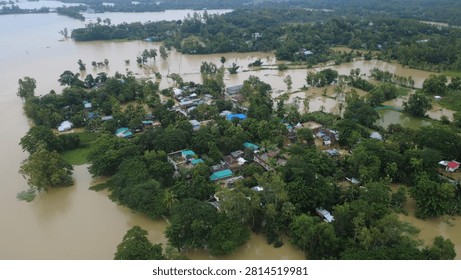 This aerial photograph captures the devastating impact of flooding in Bangladesh, where rising floodwaters have submerged roads, homes, and surrounding farmland, disrupting daily life  chittagong, Bangladesh
