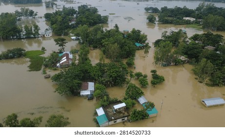 This aerial photograph captures the devastating impact of flooding in Bangladesh, where rising floodwaters have submerged roads, homes, and surrounding farmland, disrupting daily life at banshkhali, chittagong, Bangladesh